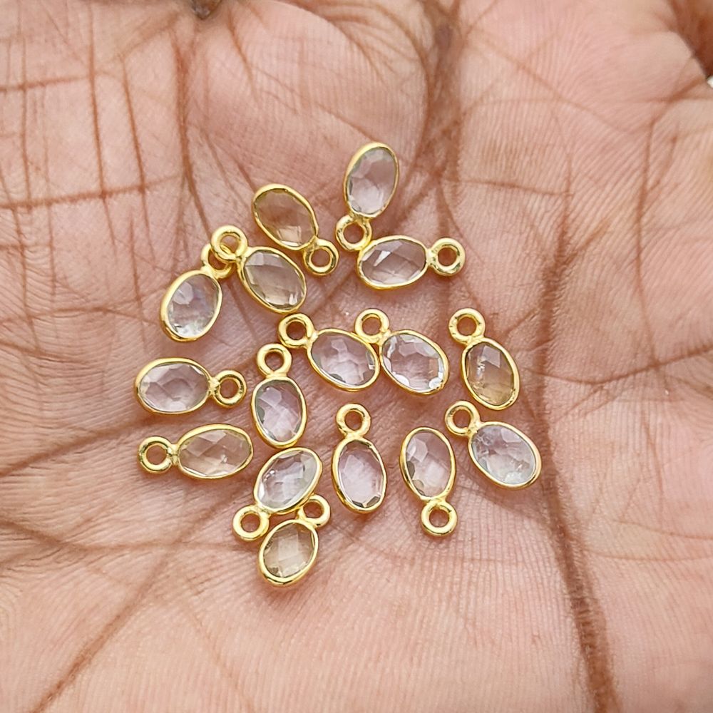 Feminine clear quartz charm necklace in gold setting