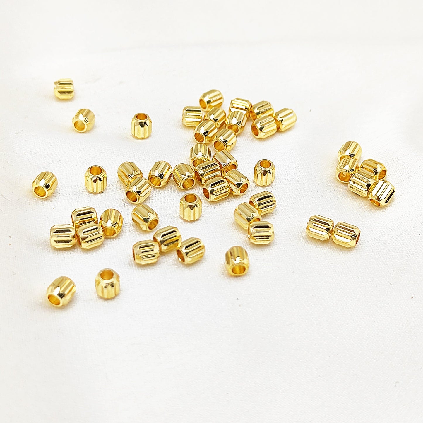 Tiny gold tube beads for jewelry making and crafting
