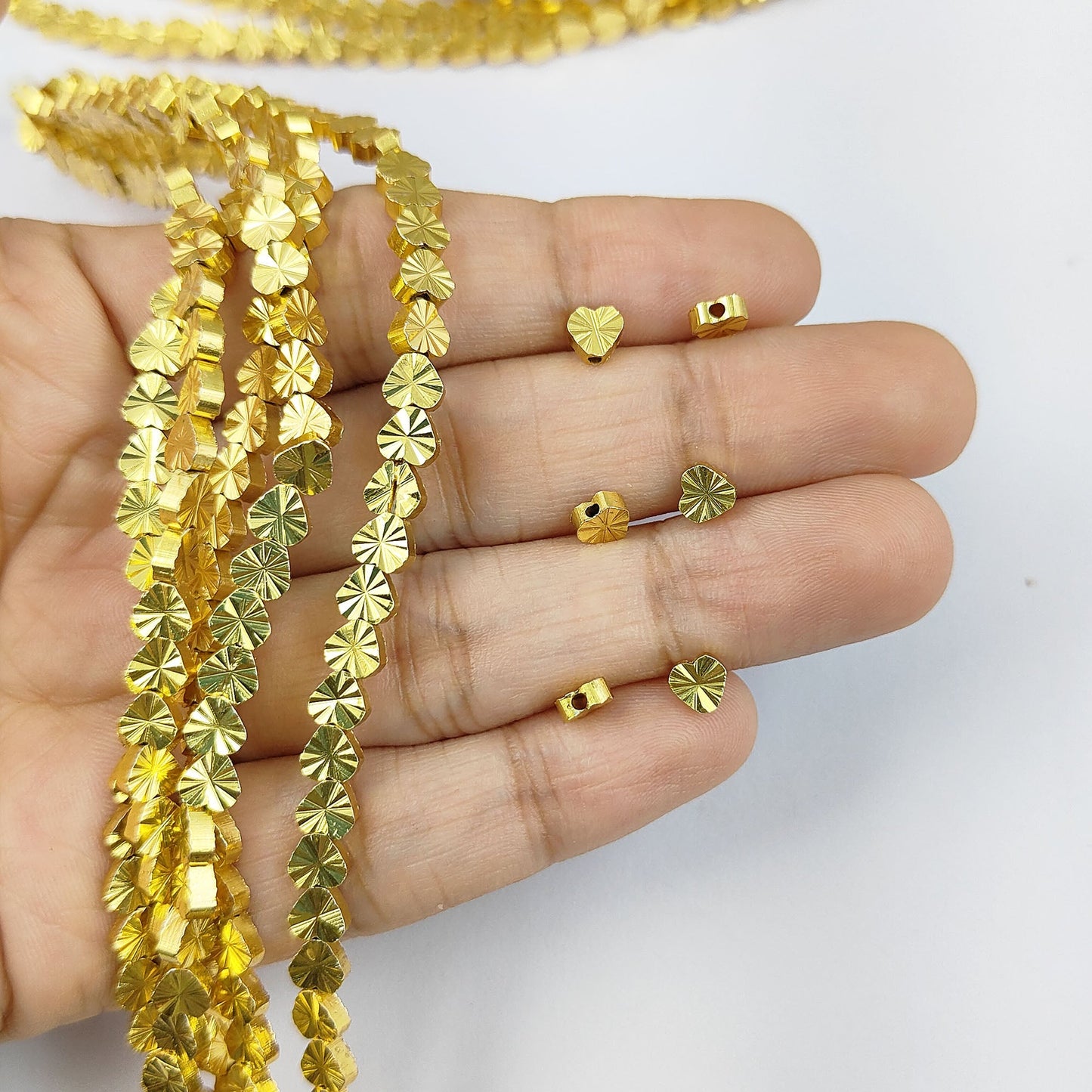 Jewelry components textured heart spacer beads in gold plating