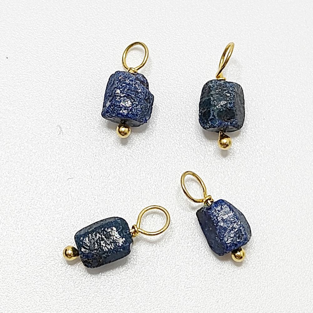 Raw blue sapphire pendant wrapped in gold-plated silver – a perfect birthstone charm for dainty jewelry