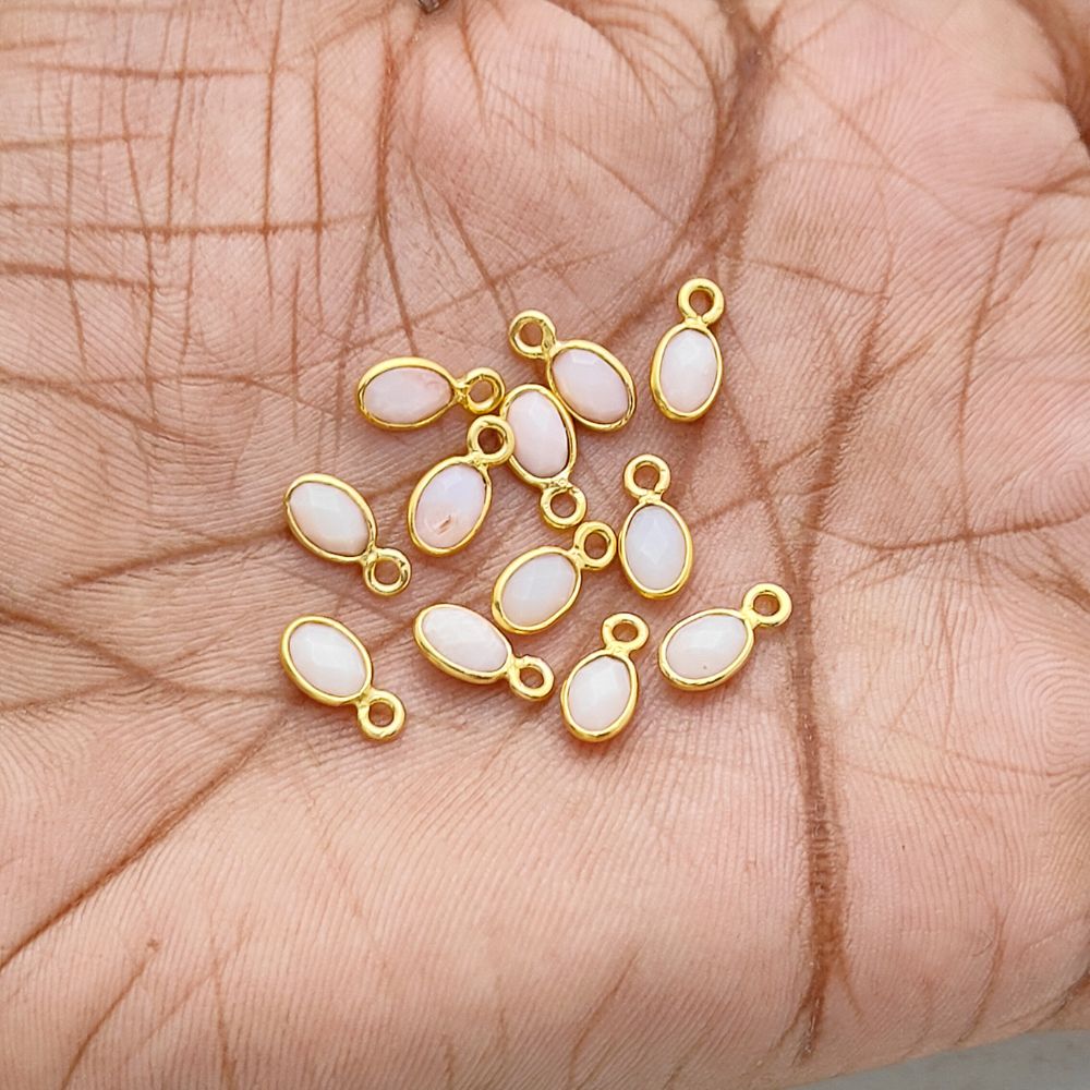 Soft pink opal gemstone pendant in gold setting