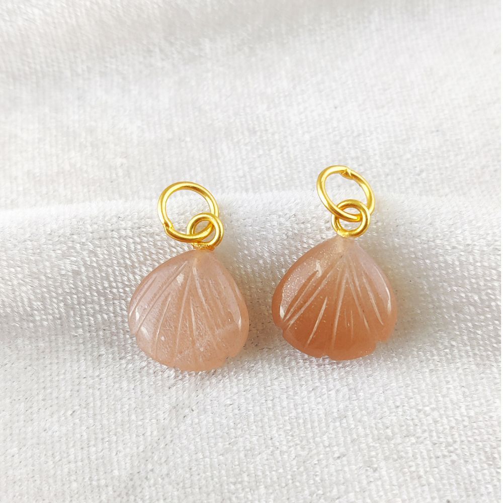 Elegant peach moonstone heart-shaped pendant set in gold-plated silver seashell design, perfect for dainty jewelry lovers.