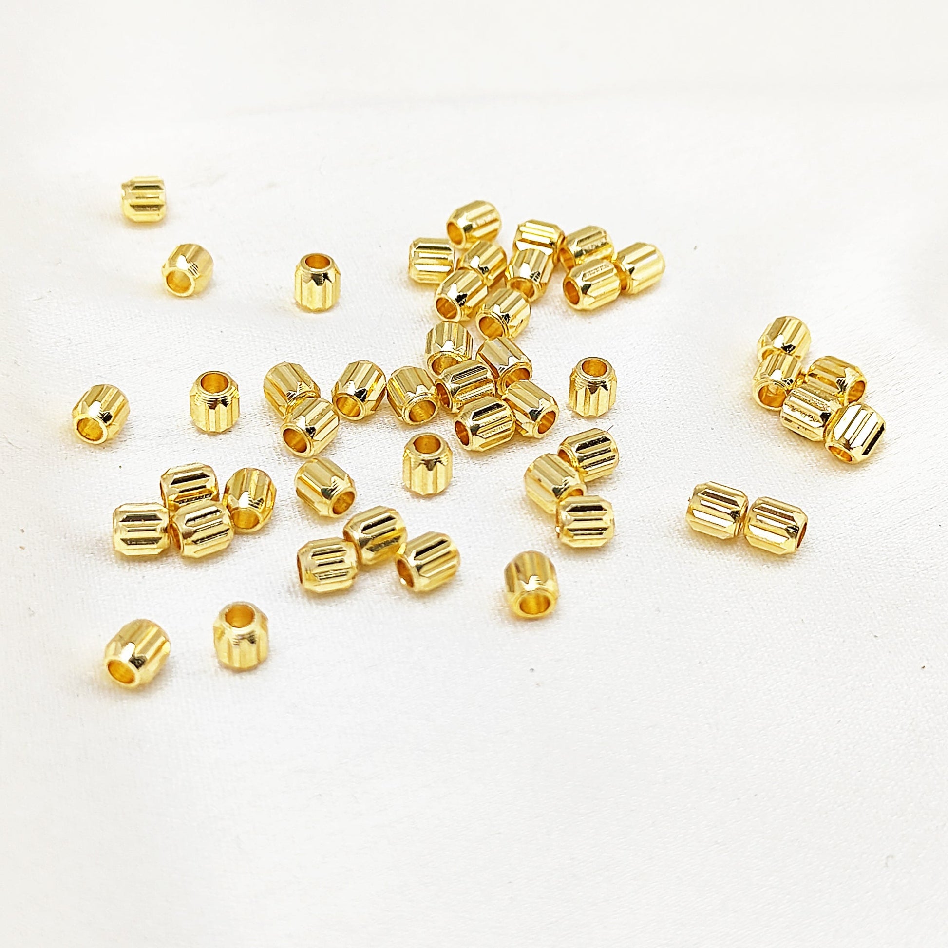 Tiny gold tube beads for jewelry making and crafting