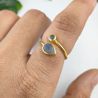 Handcrafted sterling silver ring with gold plating featuring two faceted blue labradorite stones and adjustable band
